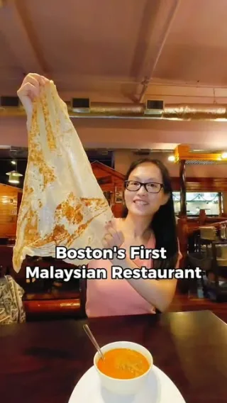 A creator sharing a meal at a Malaysian restaurant in Boston